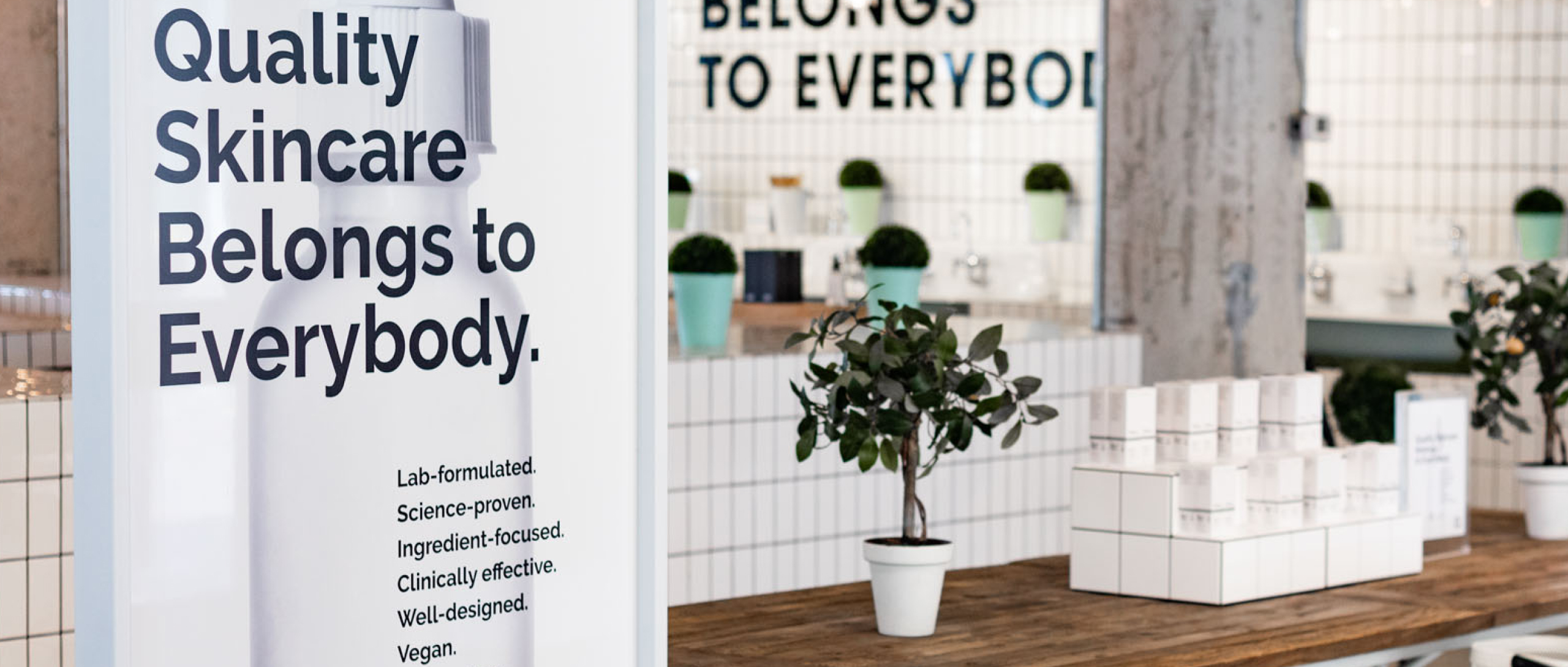 Photo of The Ordinary store interior. Sign reads Quality Skincare Belongs to Everybody 